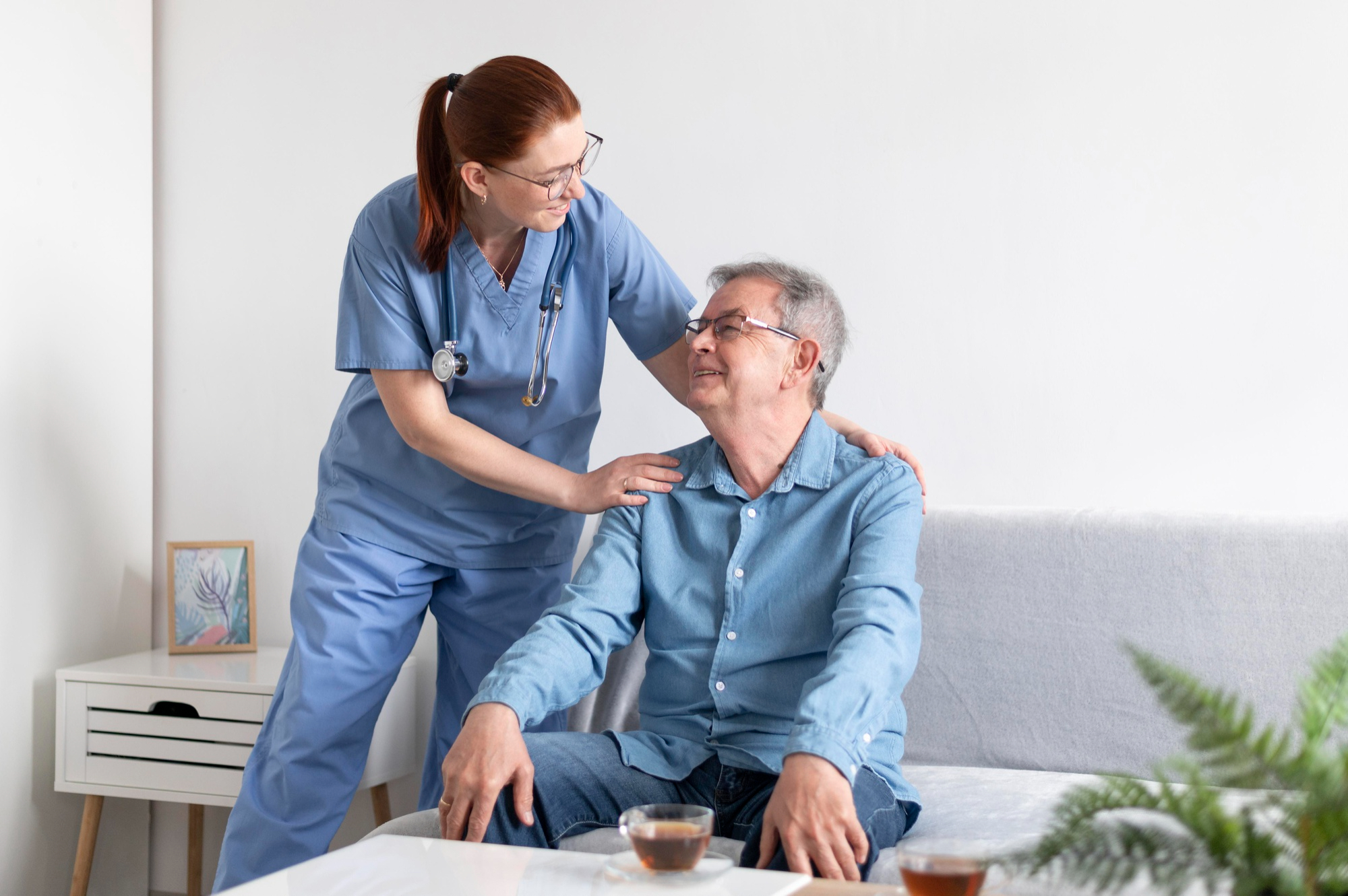 Licensed nurse assessing elderly seated patient during home health visit — Innovation Home Health Florida